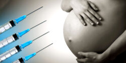 pregnant belly and 4 vaccine syringes