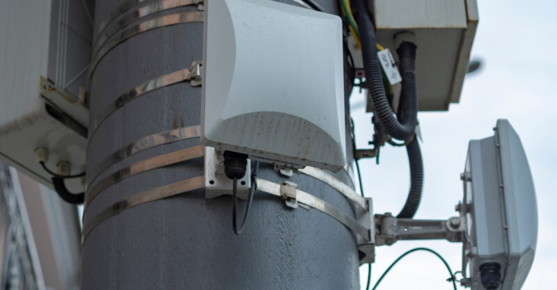 Photo Cellular repeater antennas installed on pole in residential neighborhood.