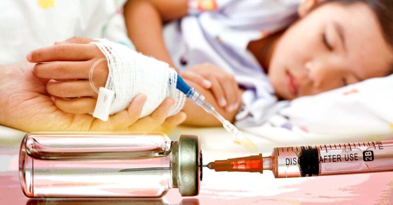 child in hospital and vaccine bottle