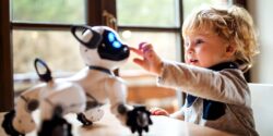 child playing with robot dog toy