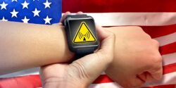 american flag and hand holding smart watch with RF radiation symbol
