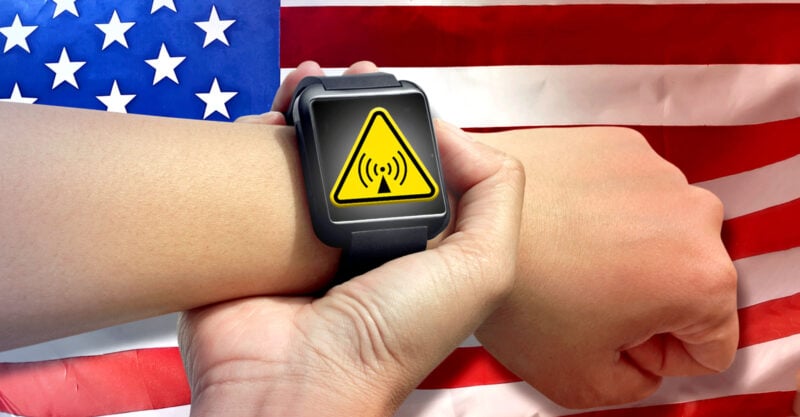 american flag and hand holding smart watch with RF radiation symbol