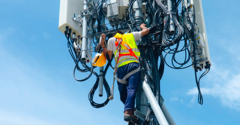 Photo of man working on cell tower