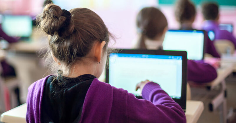 School kids using laptops in the classroom.