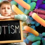 gut microbes and boy holding sign that reads "autism"