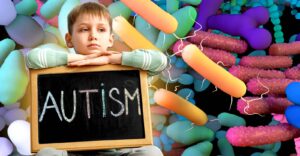 gut microbes and boy holding sign that reads "autism"