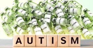 vaccine bottles and word "autism"