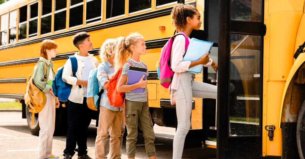 kids getting on school bus