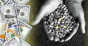 hand holding corn seeds and money