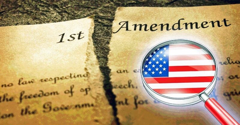 first amendment and magnifying glass with flag