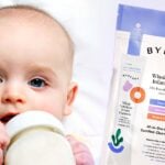 baby drinking milk and package of byheart