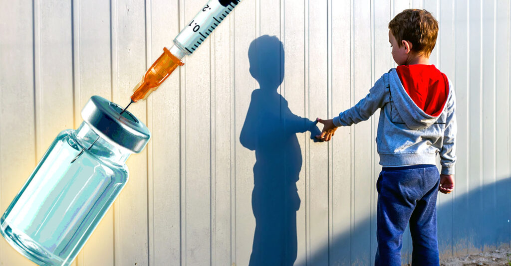 boy looking at wall and vaccine bottle