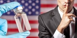 vaccine bottle and person giving the quiet sign