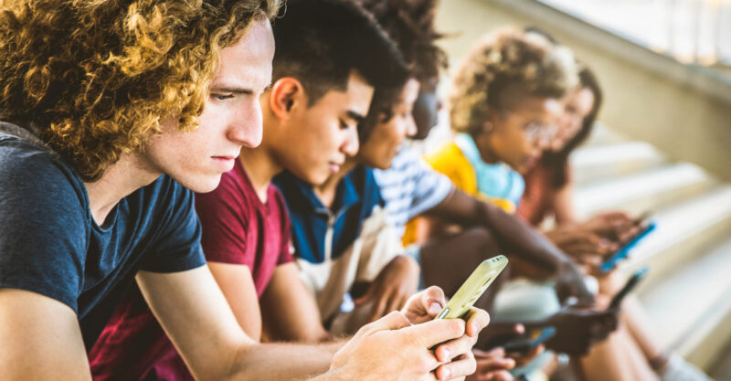 Cell phones and health, image of teens using cell phones