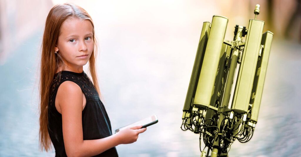 girl holding cellphone and cell tower