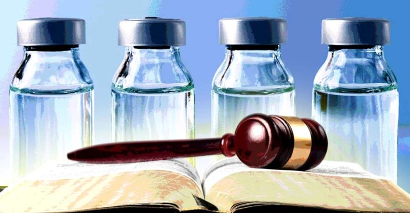 vaccine bottles with gavel on book