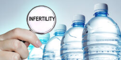 Water bottles with a magnifying glass with infertility written inside