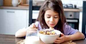 young girl eating bowl of cereal