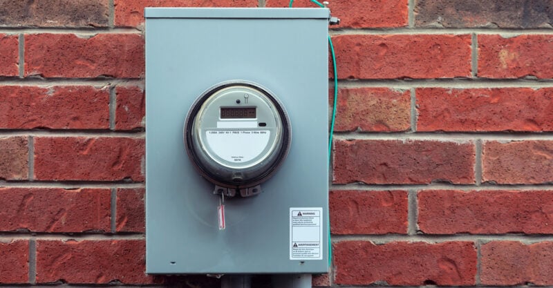 Smart meter installed on side of brick home.