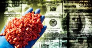 money and glove holding coated seeds