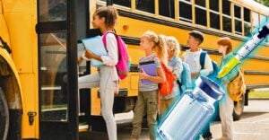 kids on bus and a vaccine bottle