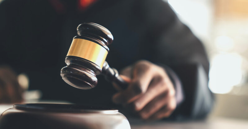 Judge with gavel on table