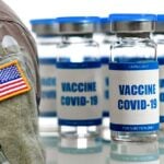 u.s. military uniform and covid vaccine bottle