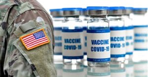 u.s. military uniform and covid vaccine bottle