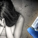 woman and covid vaccine bottle