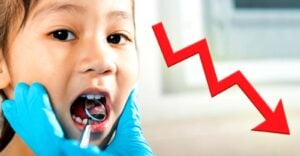 child at dentist and arrow going down