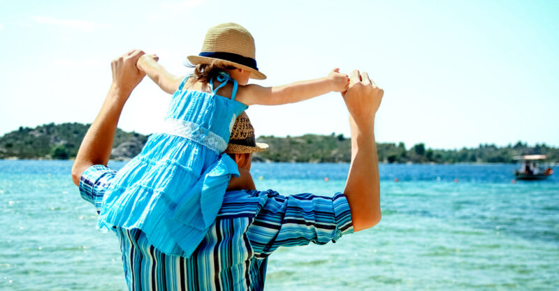 father with daughter on his shoulders