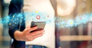 woman holding cell phone and social media icons