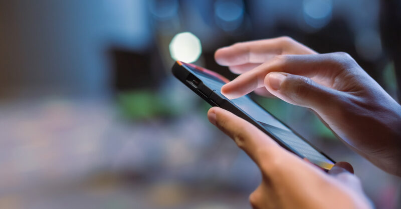 Man holding and using smart phone
