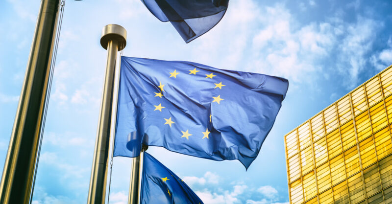 EU Commission Flags in front of EU Commission Building.