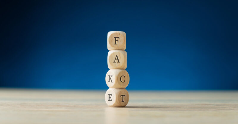 Letter dice showing both fake and fact