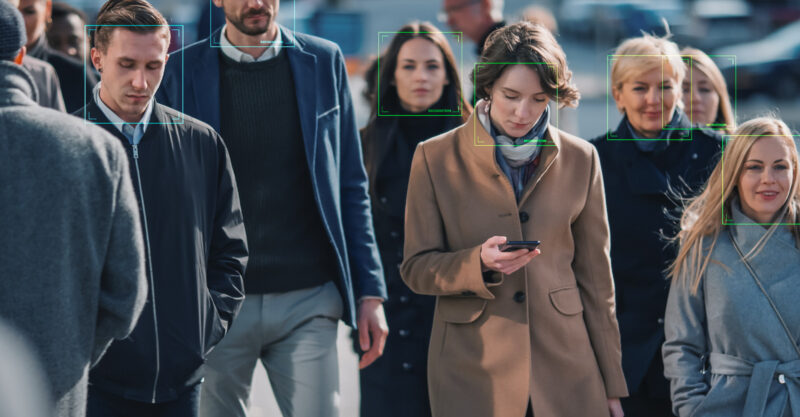 Crowd of Business People Tracked with Technology Walking on Busy Urban City Streets. CCTV AI Facial Recognition Big Data Analysis Interface Scanning