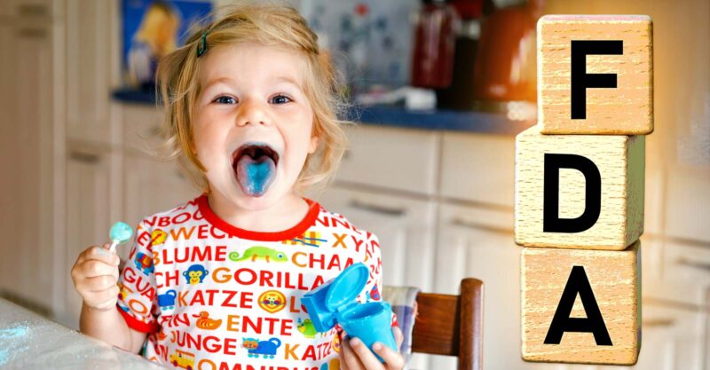 girl with blue tongue eating candy and letters "fda"