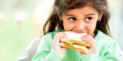 young girl eating sandwich
