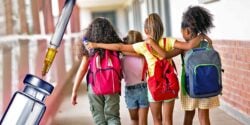 school kids and vaccine bottle