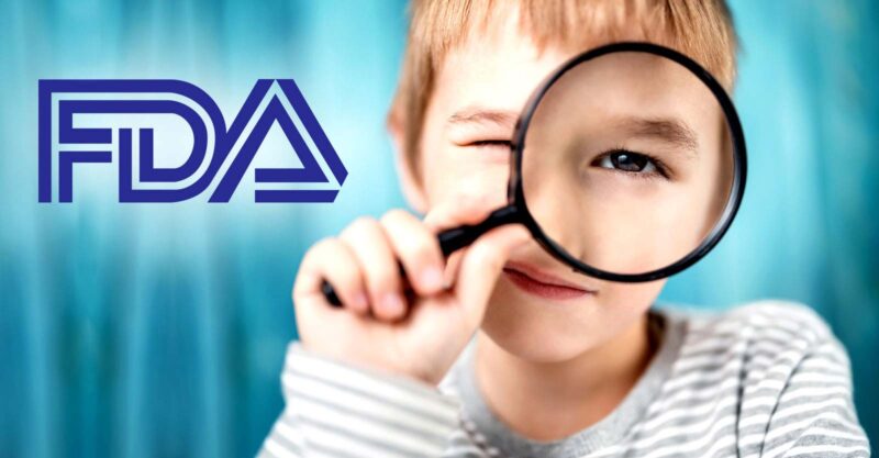 boy holding magnifying glass and FDA logo