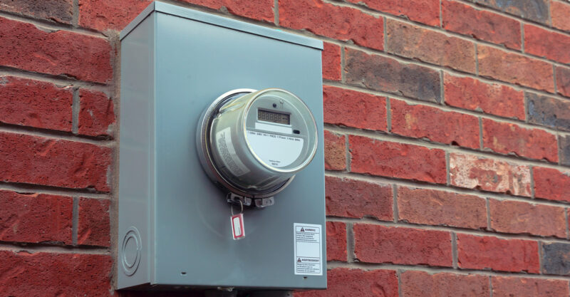 Smart meter on installed on brick house.