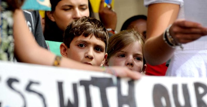 Two of the children involved in EHN's study participate in a 2019 youth climate change protest in downtown Pittsburgh. Photo credit: Connor Mulvaney for Environmental Health News