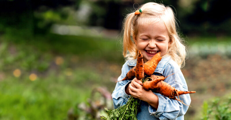 girl holding carrots