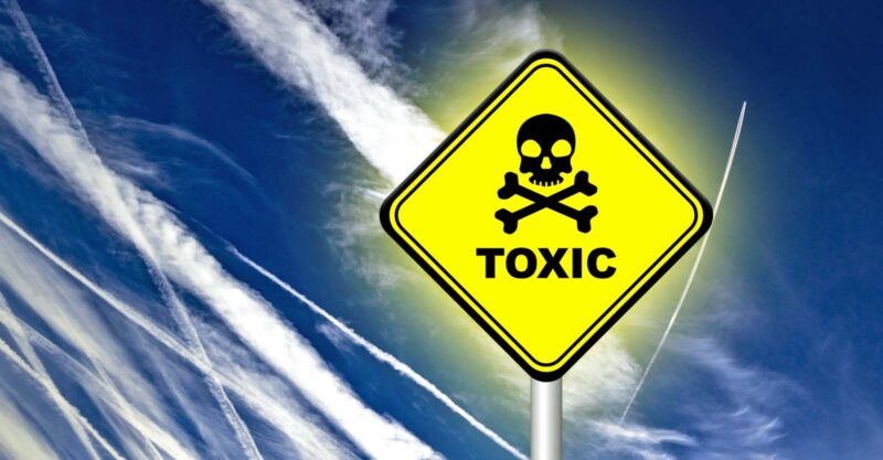 geoengineering sky and sign that reads "toxic"