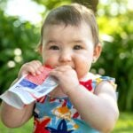 baby eating fruit pouch