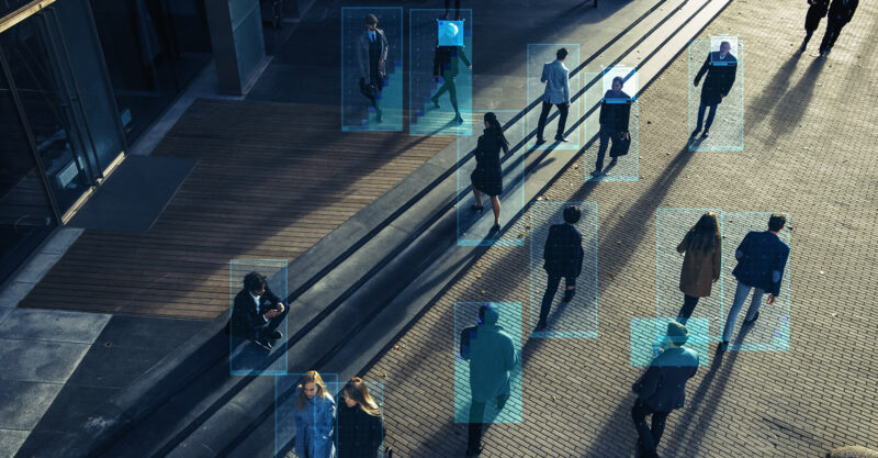 Elevated Security Camera Surveillance Footage of a Crowd of People Walking on Busy Urban City Streets. CCTV AI Facial Recognition Big Data Analysis Interface Scanning