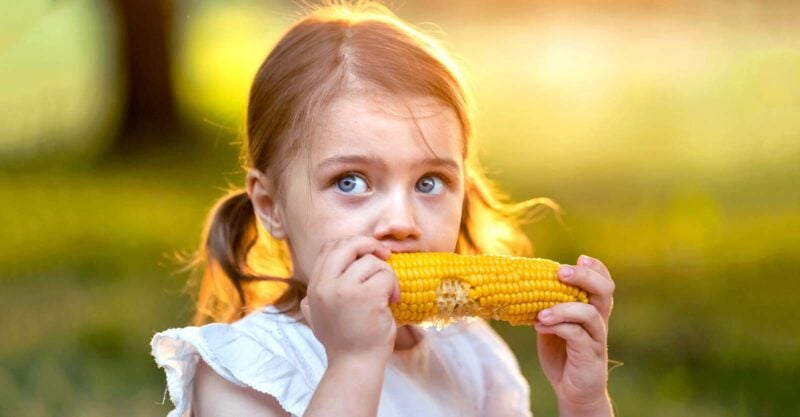 girl eating corn