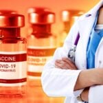 covid vaccine bottles and healthcare worker