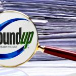 roundup logo and stack of papers