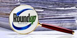 roundup logo and stack of papers